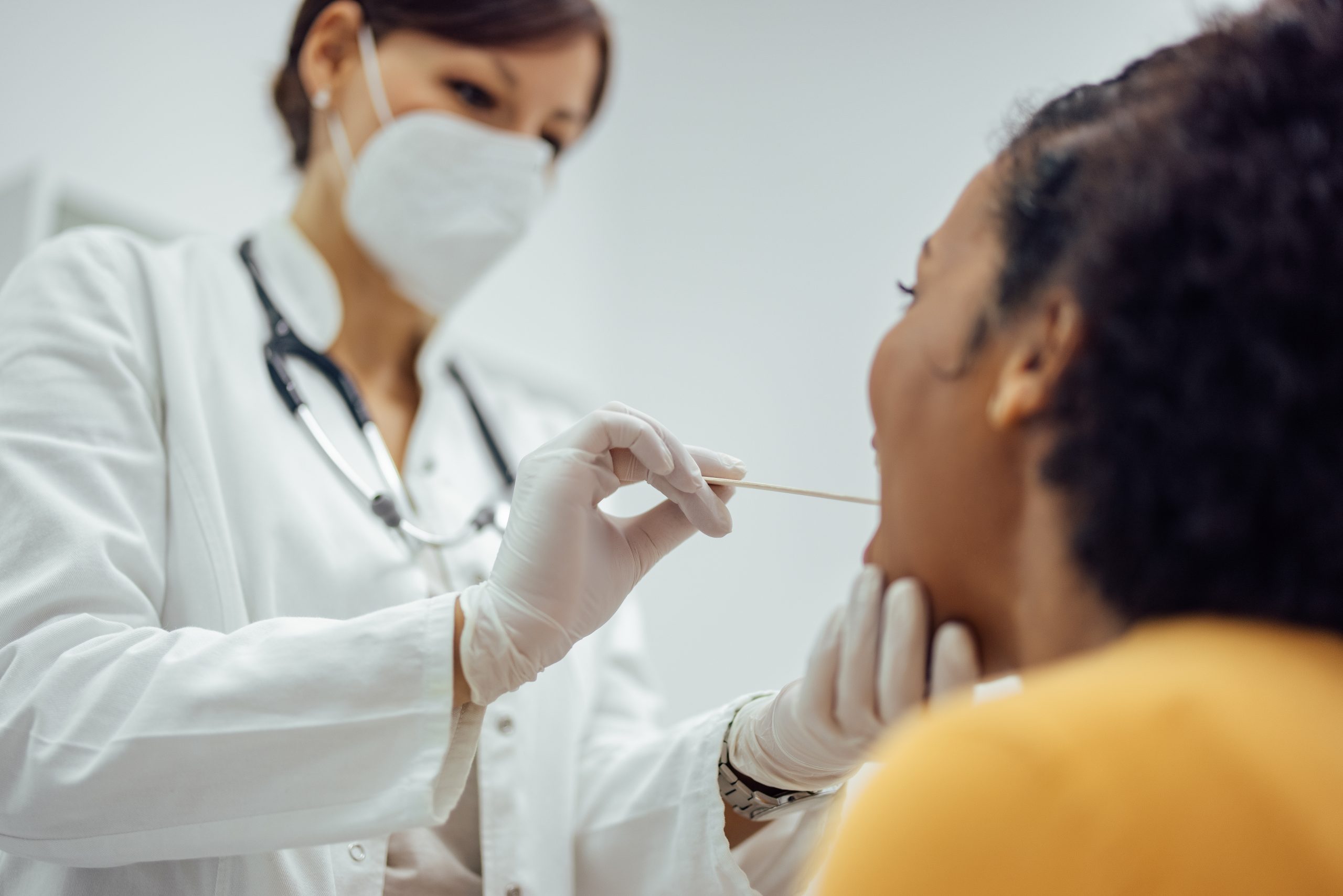 throat examination at doctor's office.